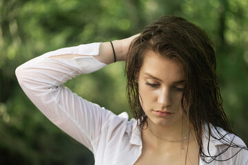 Portrait of a young brunette with wet hair. Horizontal. 
