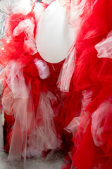 Red and white tulle fabric background with white blank circle for lettering.