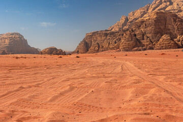 Wadi Rum desert landscape with tire tracks of off-road vehicles. Jordan. Horizontally. 