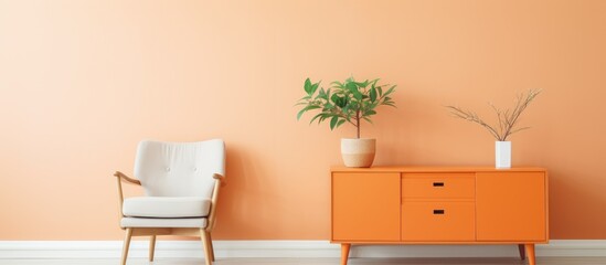 The living room features orange walls, a matching dresser, a chair, and a potted plant by the window, creating a vibrant and cozy interior design