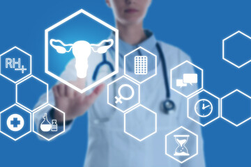 Menopause concept. Doctor touching uterus icon on digital screen against blue background, closeup