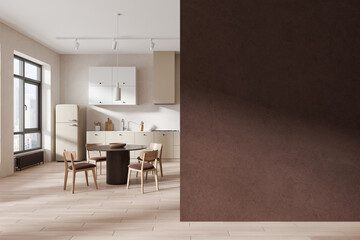 Stylish home kitchen interior with dining table and cabinet, window. Empty wall