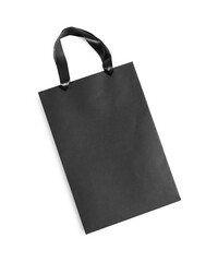One black paper shopping bag on white background, top view. Space for text