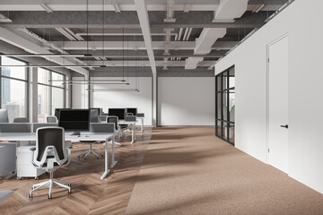 Stylish coworking room interior with pc computers on table, panoramic window