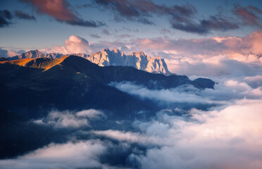 A gorgeous view of rocky peaks surrounded by fog. Italian Alps, Dolomites, South Tyrol, Europe.