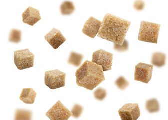 Brown cane sugar cubes falling on white background