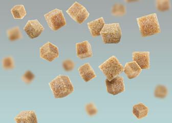 Brown cane sugar cubes falling on color gradient background