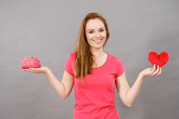 Woman holds brain and heart