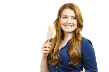 Woman brushing long healthy brown hair