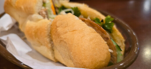 Sandwich Banh mi, vietnamese baguette with grilled chicken and mixed salad, vietnamese sandwich