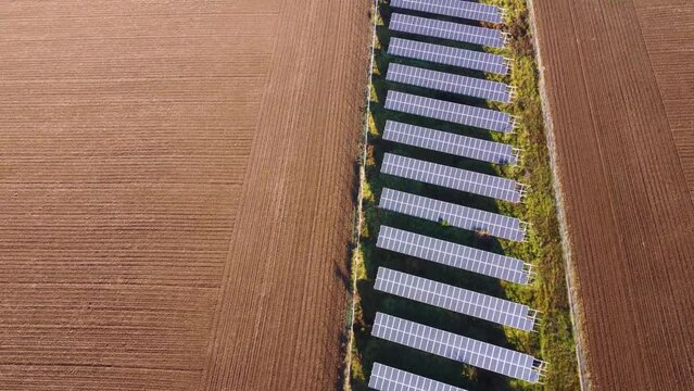 Solar panels farm in the middle of a plowed field