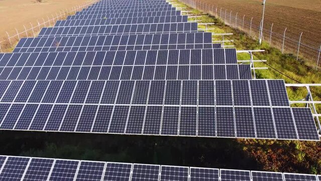 Solar panels farm in the middle of a plowed field