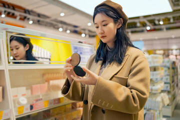 Fashionable Young Woman Shopping for Cosmetics in Store