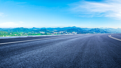 Empty asphalt road and modern city skyline with mountains in Shenzhen - Powered by Adobe