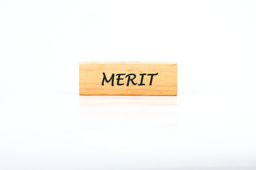 Merit word written on wooden block