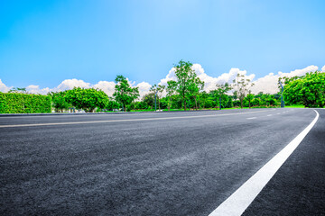 Empty asphalt road and woods background