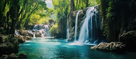 A majestic waterfall flows in the heart of a lush forest, surrounded by towering trees and a serene natural landscape of fluvial landforms - obrazy, fototapety, plakaty