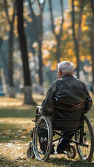 Elderly man sitting alone in a wheelchair in a park. Solitude and contemplation, highlighting the concept of loneliness and life during retirement. 