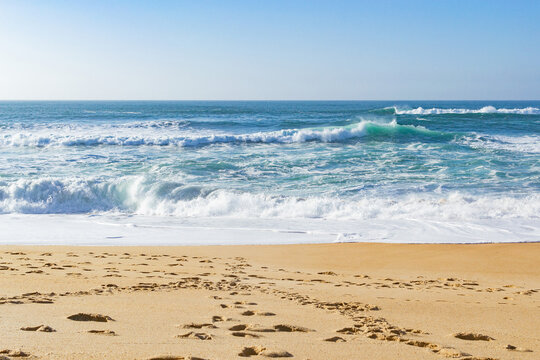 Beautiful ocean waves on a golden sand beach. Alone with nature.