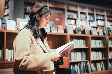 Young Woman Enjoying a Book in Cozy Library Corner