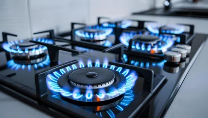 Foto op Plexiglas Closeup shot of blue fire from domestic kitchen stove top. Gas cooker with burning flames of propane gas © Oleksiy