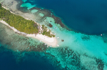 Aerial view of a tropical island with palm trees and white sand beaches. Amazing tropical island in the middle of the ocean. .