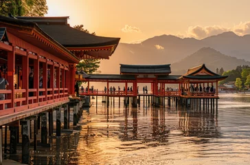 Foto op Aluminium The red torii gate of Itsuk Japanese temple stands on the water surface at sunset © Kien