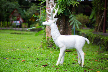 White deer statue in the forest