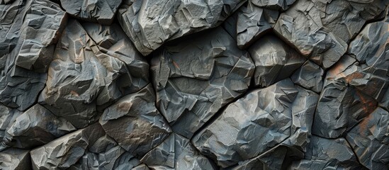 Closeup shot of a stack of bedrock rocks in a pattern, with soil and water surrounding it. An automotive tire, plant trunk, and wood outcrop are also visible