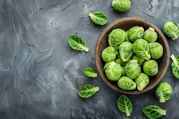Foto op Plexiglas Organic green brussels sprouts in a bowl on a grey background. Top view. Copy space. © Tanya