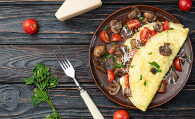 Omelette stuffed with mushrooms , tomatoes and parsley - obrazy, fototapety, plakaty