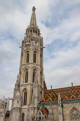 Fototapeta na wymiar Famous historic Matthias Church in Budapest, Hungary, a must-visit landmark. Gothic architectural and decorative colorful powerful style, Catholic church with neo-Gothic style, hosts royal events