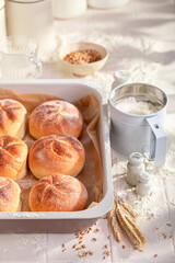 Hot and golden kaiser buns freshly baked in home bakery.