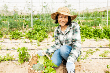 Happy southeast Asian woman working inside agricultural greenhouse - Farm people lifestyle concept