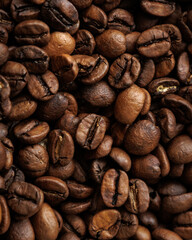 coffee beans are on table after roasting. Fresh converted coffee beans before packing in paper bag. Ground coffee for making Americano or cappuccino. grain cultivation and harvesting