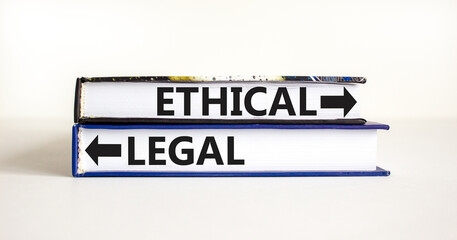 Ethical or legal symbol. Concept word Ethical or Legal on beautiful books. Beautiful white table...