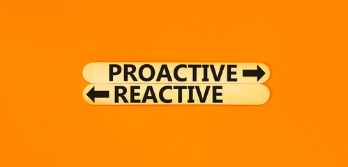 Proactive and reactive symbol. Concept word Proactive Reactive on beautiful wooden stick. Beautiful...
