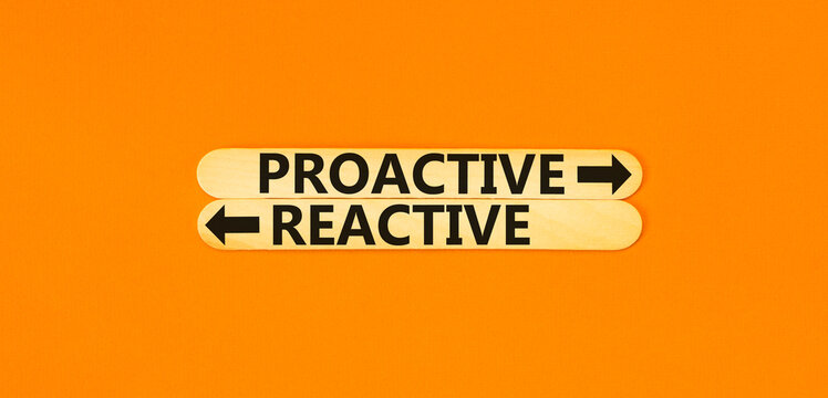 Proactive and reactive symbol. Concept word Proactive Reactive on beautiful wooden stick. Beautiful orange table orange background. Business proactive and reactive concept. Copy space.