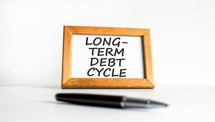 Long-term debt cycle symbol. Concept words Long-term debt cycle on beautiful white wooden frame. Black pen. Beautiful white background. Business Long-term debt cycle concept. Copy space.