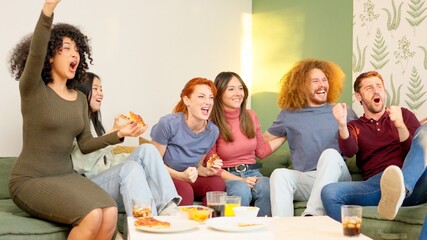 Friends eating pizza and celebrating the victory of their team