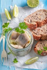 Healthy and tasty marinated herring with oil in jar. - 766314405