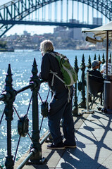 People Tourists sightseeing and strolling Sydney Harbour in winter sparkling waters and iconic sight Australia