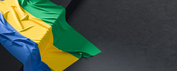Flag of Gabon. Fabric textured Gabon flag isolated on dark background. 3D illustration - 766317889