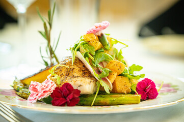 Pan seared halibut filet over asparagus topped with diced peaches