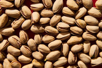 Pistachios on vibrant red background. Retro style food photography.
