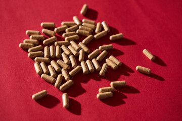 Medical Pills on vibrant red background. 80s and 90s retro style, hard light and contrast shadows. Top view.
