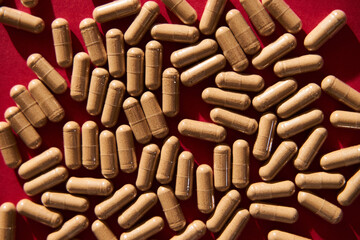 Medical Pills on vibrant red background. 80s and 90s retro style, hard light and contrast shadows....