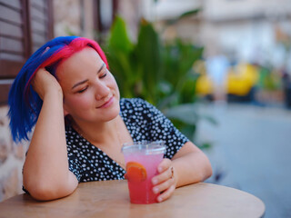 female summer old town walk in Antalya Turkey. Woman with colorful hair and dress strolls through...