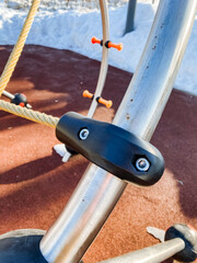 Closeup of a metal bicycle spoke with a screw on it