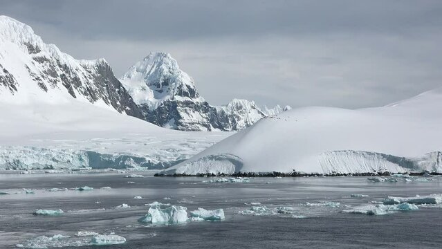 Antarctica. Snowy mountains and icebergs. Cruise Travel to the Edge of the Earth. Amazing beautiful views of Nature and landscape of snow, ice and white of Antarctic. Best travels in the world.